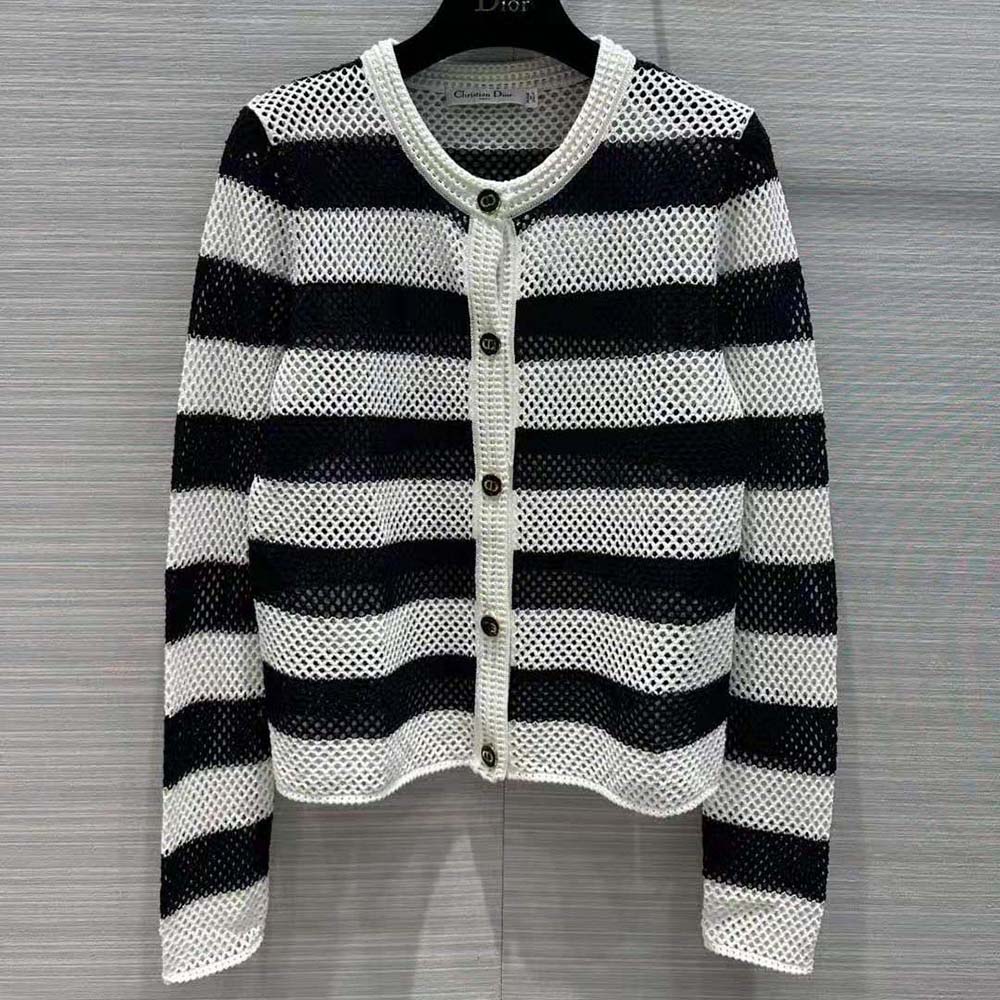 Close-up of openwork detailing and signature buttons on Dior cardigan
