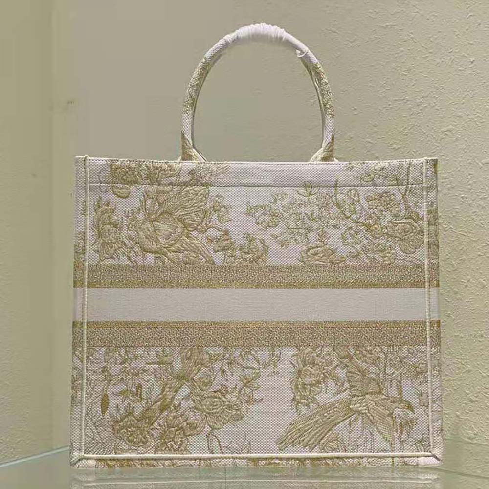 Side angle showing beige cotton canvas and structured silhouette of Dior tote