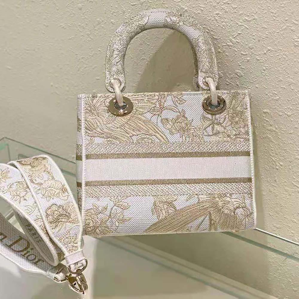 Side angle showing structured silhouette and gold hardware of Dior Women Medium Lady D-lite Bag