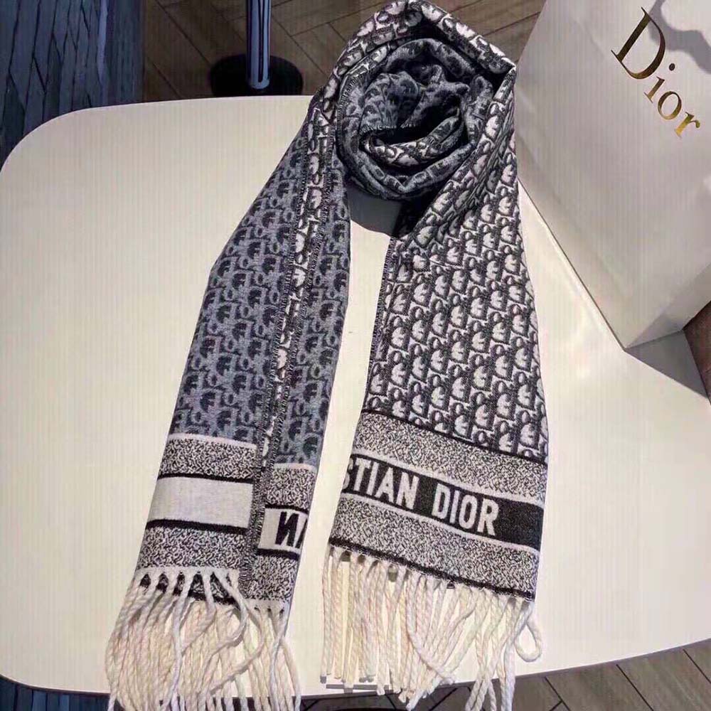 Close-up of signature Dior Oblique pattern on navy scarf