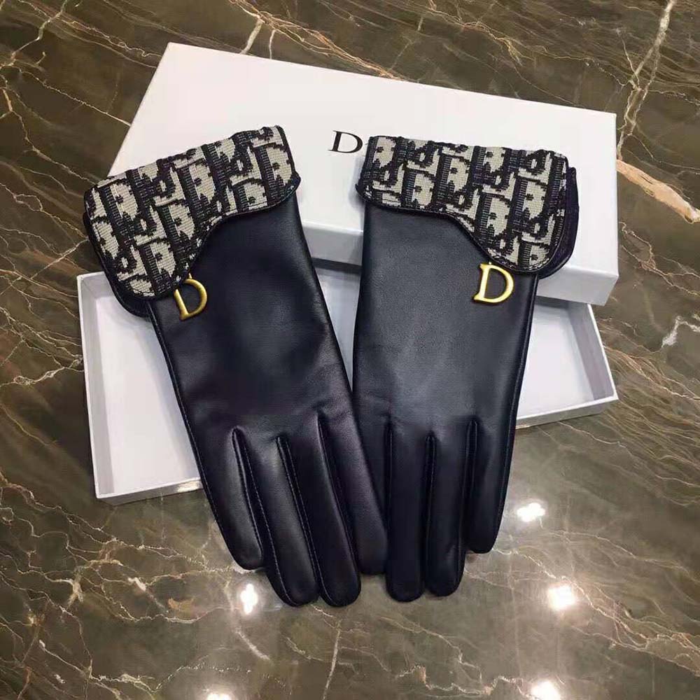 Close-up detail of navy blue lambskin and Dior signature on gloves