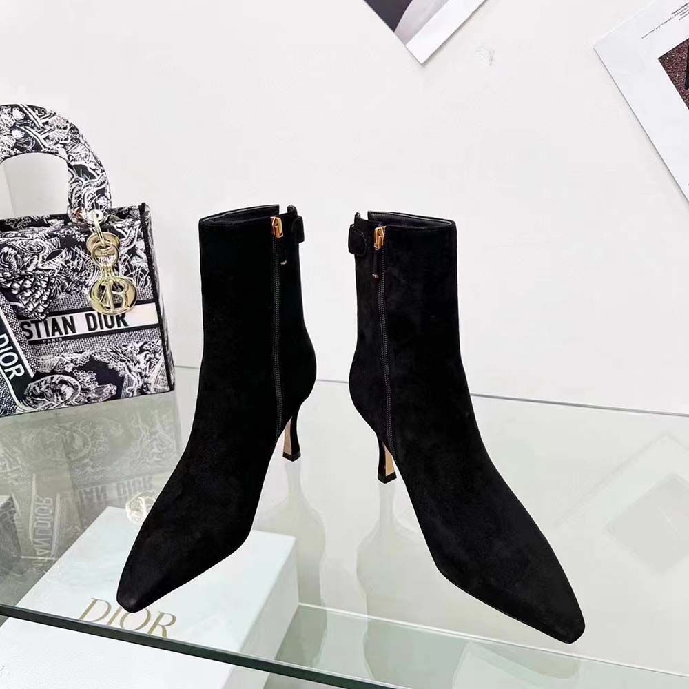 Close-up of signature Dior hardware on ankle boot heel