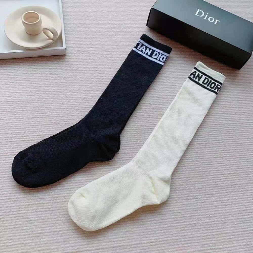 Close-up of signature Dior stripe detail on sporty high socks