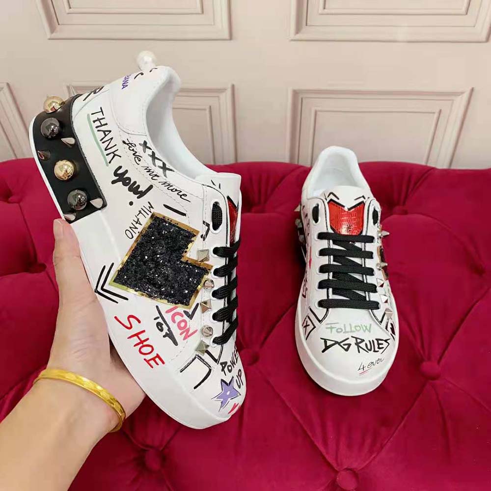Close-up of signature D&G logo patch on black calfskin Portofino sneakers