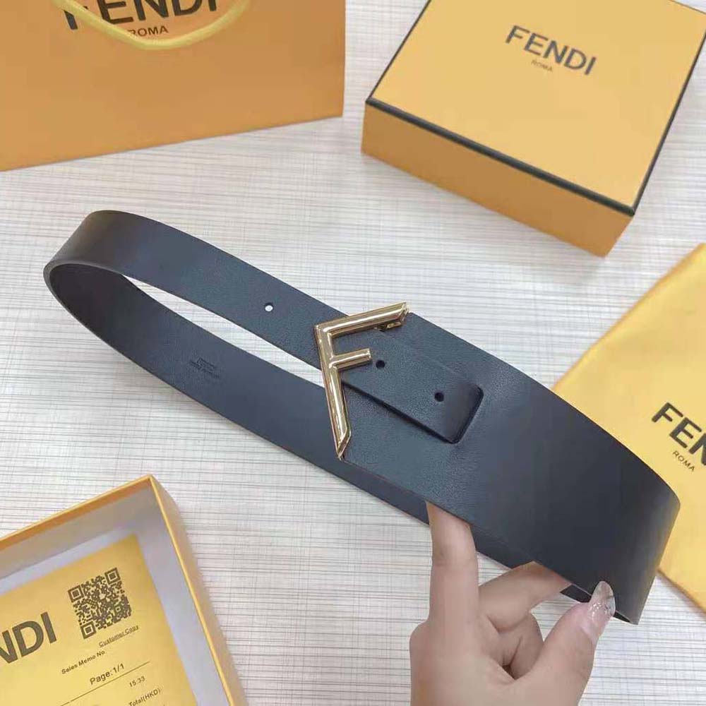 Close-up of Fendi logo on black leather belt buckle