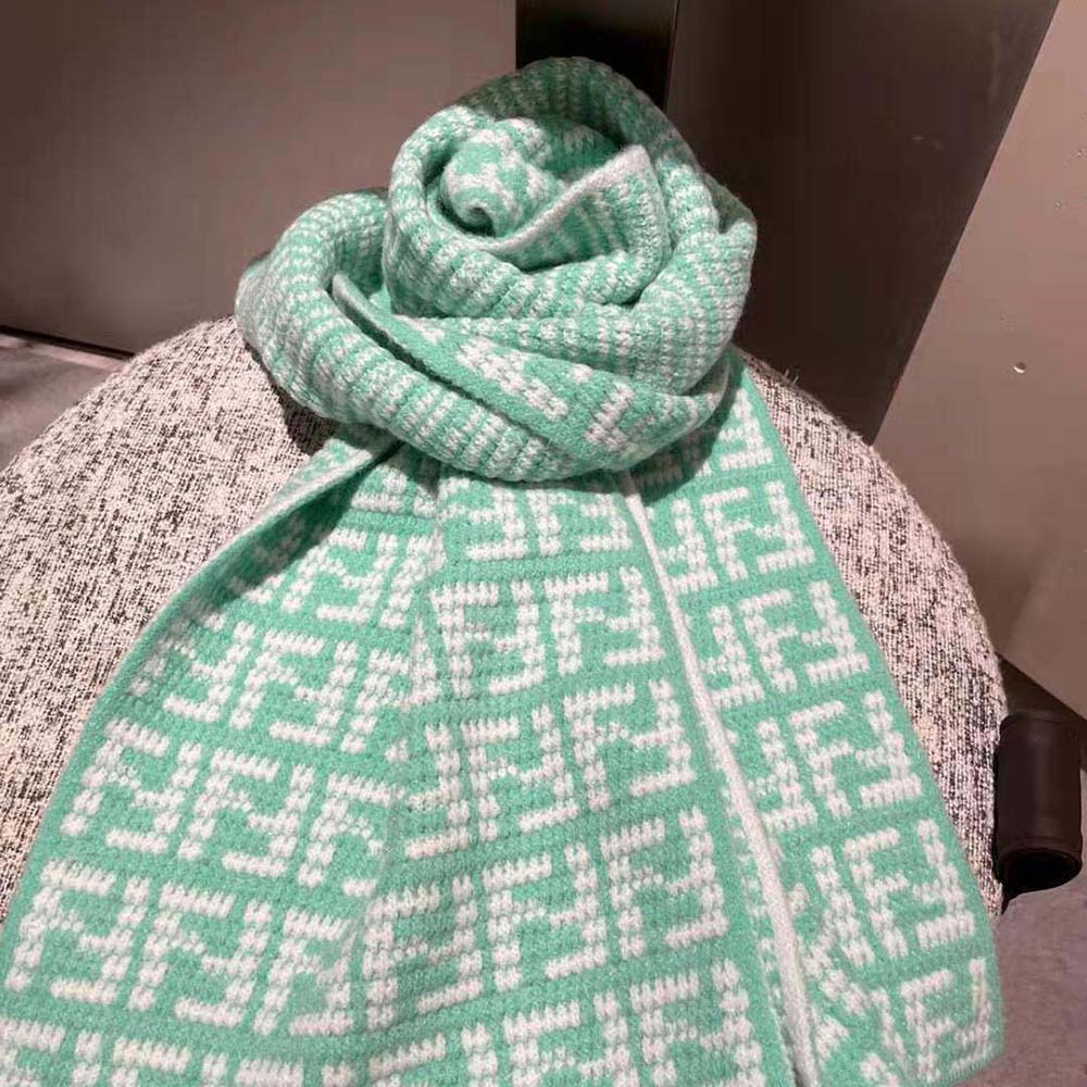 Close-up of Fendi woven FF logo detail on mint green cashmere scarf