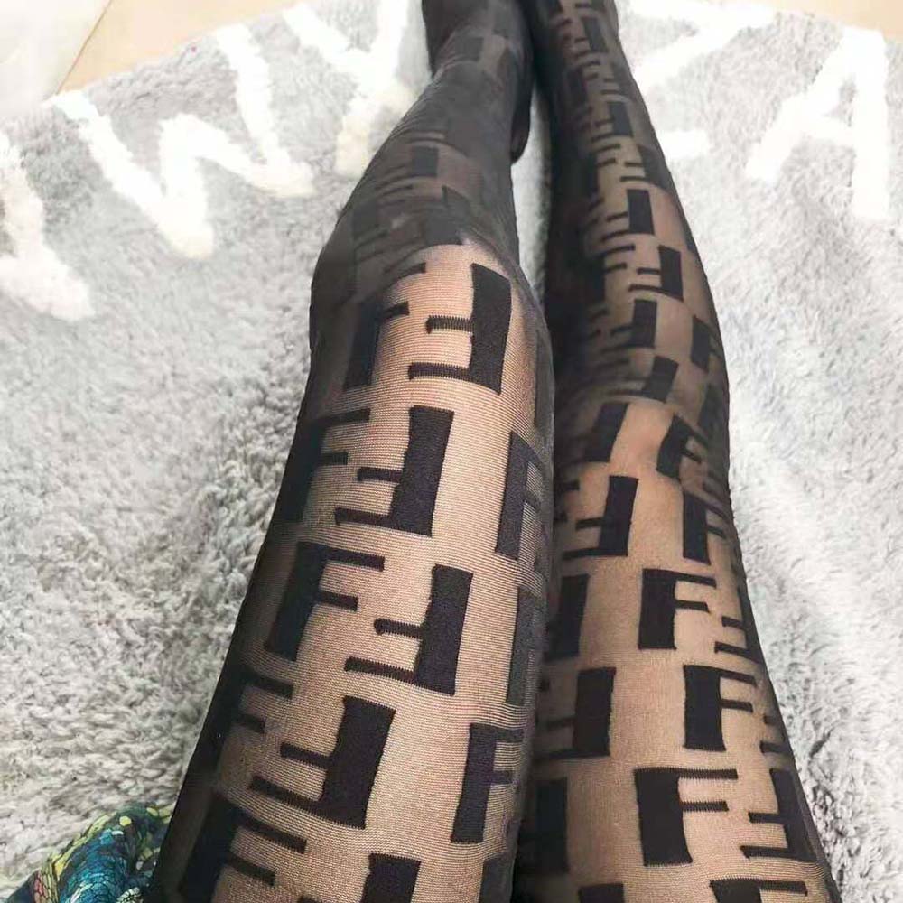 Close-up detail of black nylon fabric and Fendi logo on pantyhose