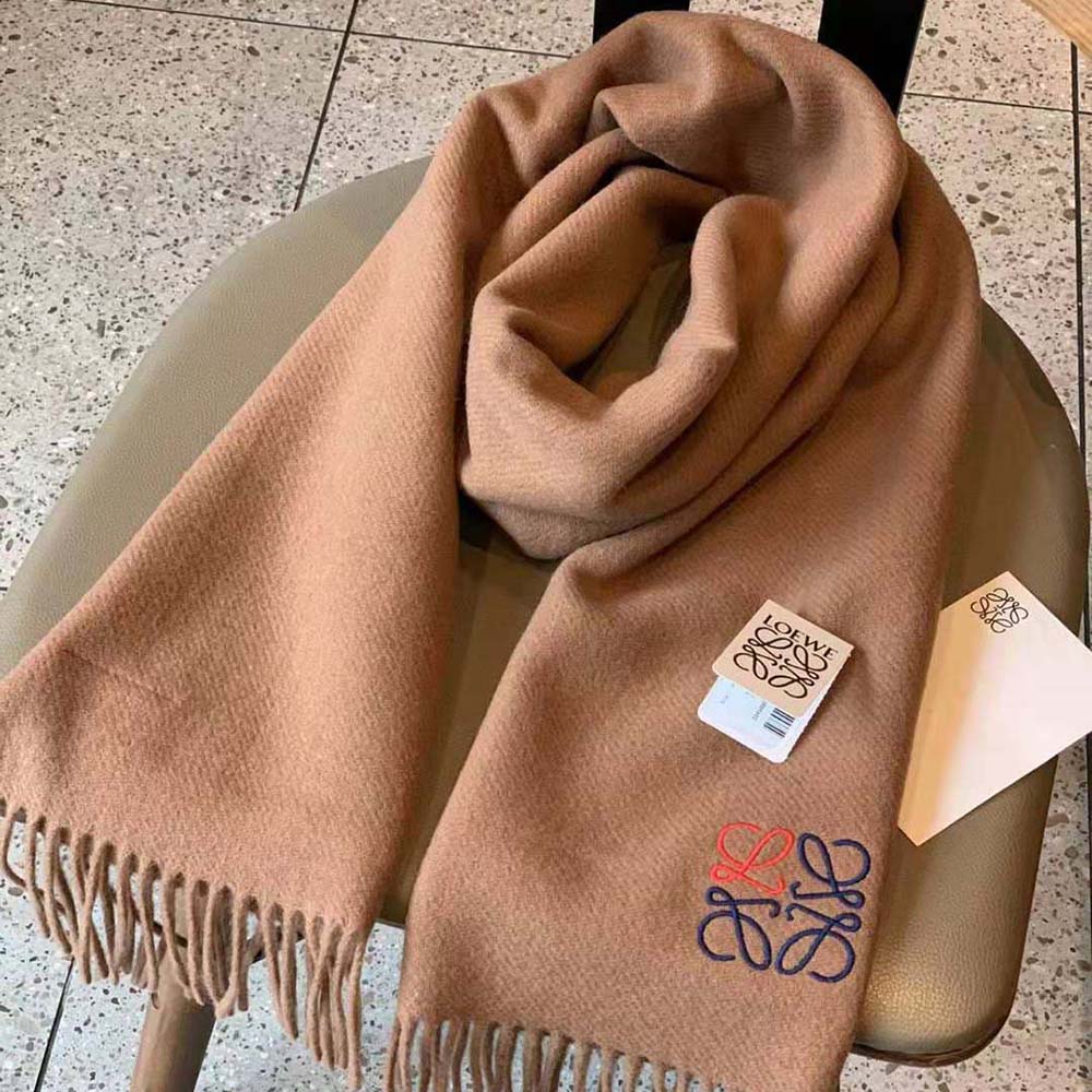 Close-up of embroidered Loewe Anagram on brown cashmere scarf