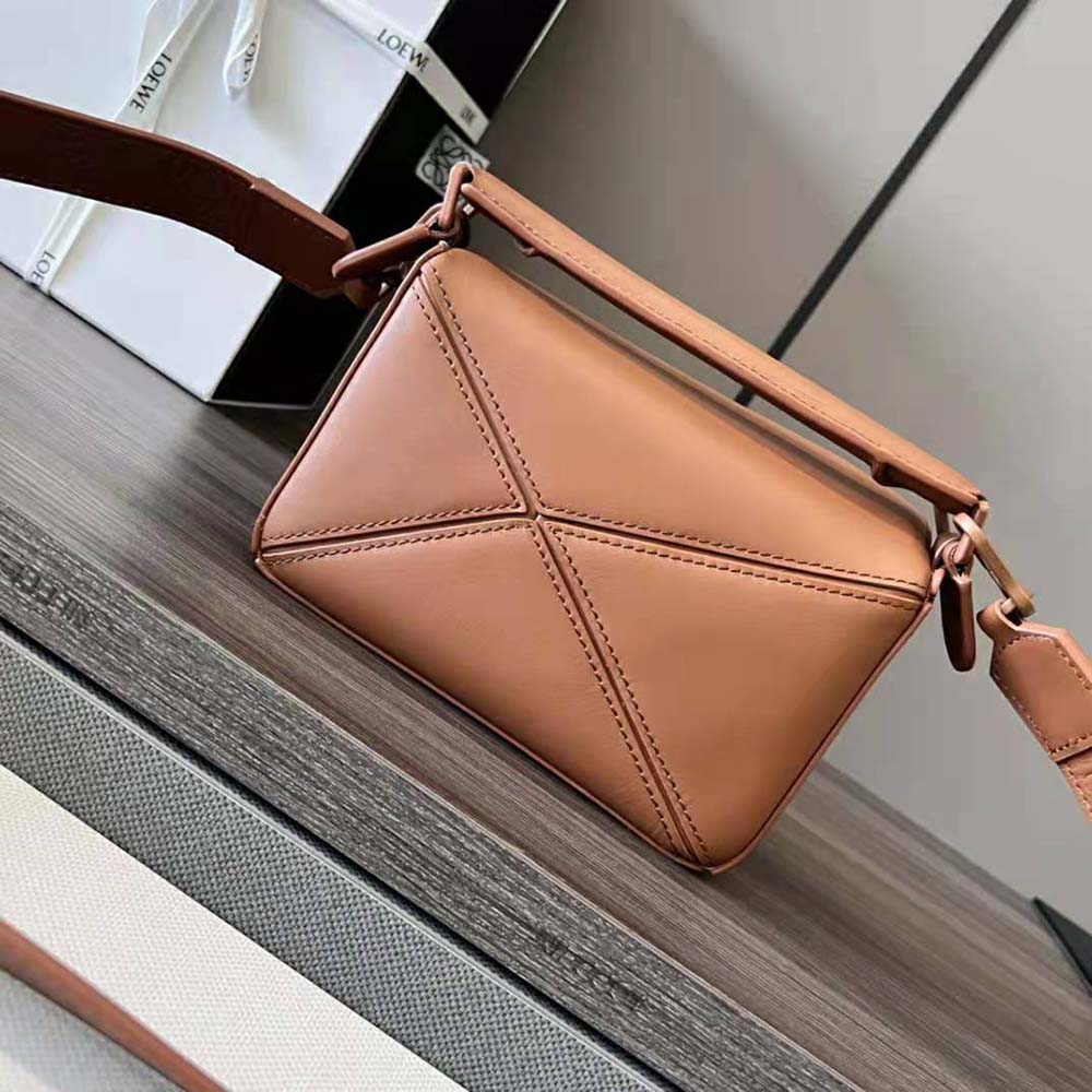 Side angle showing silhouette of Loewe Women Mini Puzzle Bag in brown leather