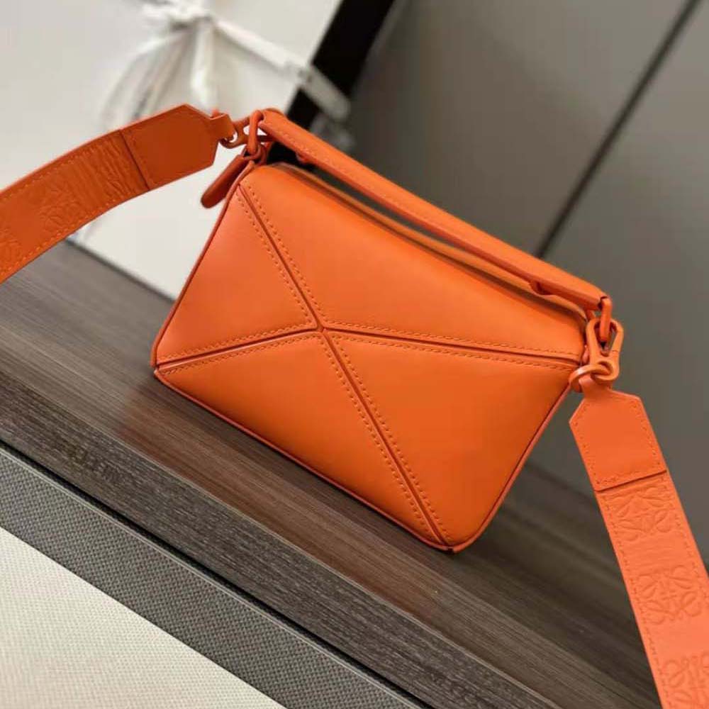 Close-up of magnetic closure detail on Loewe Mini Puzzle Bag orange