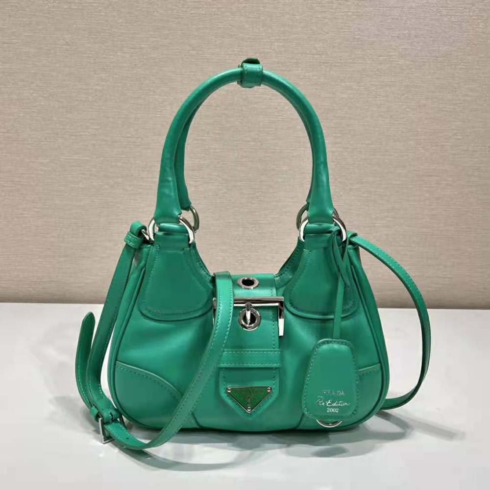 Close-up of silver-tone hardware and Prada logo on green shoulder bag