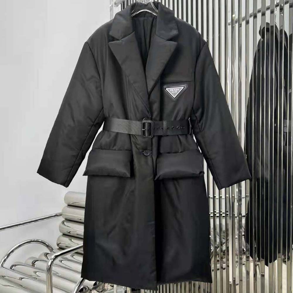 Close-up of enameled metal triangle logo on Prada black down coat
