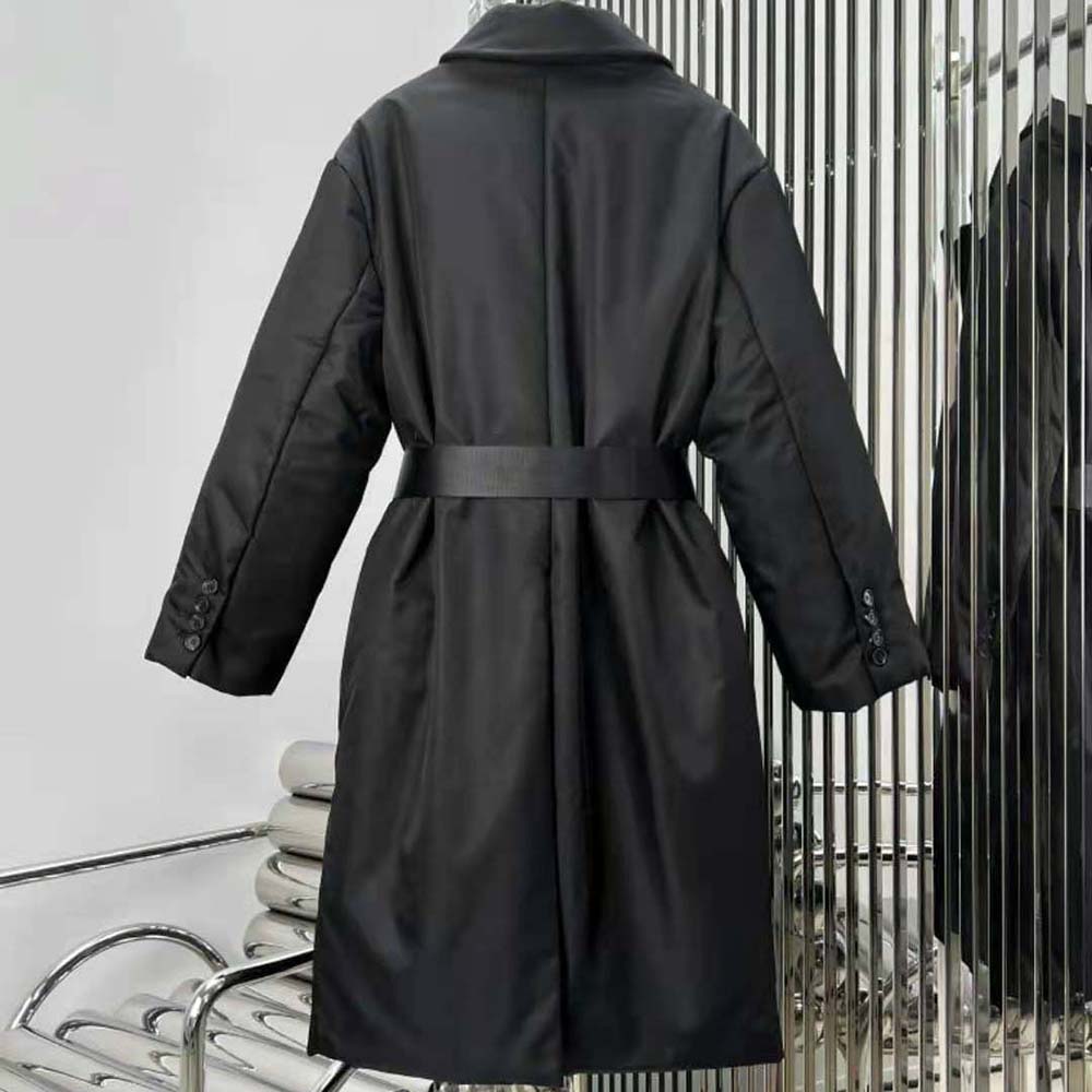 Side profile showing tailored silhouette of Prada Re-Nylon down coat