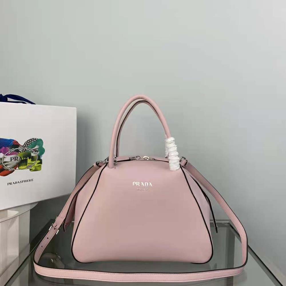 Close-up on silver-tone triangular logo of Prada Supernova Handbag-Pink