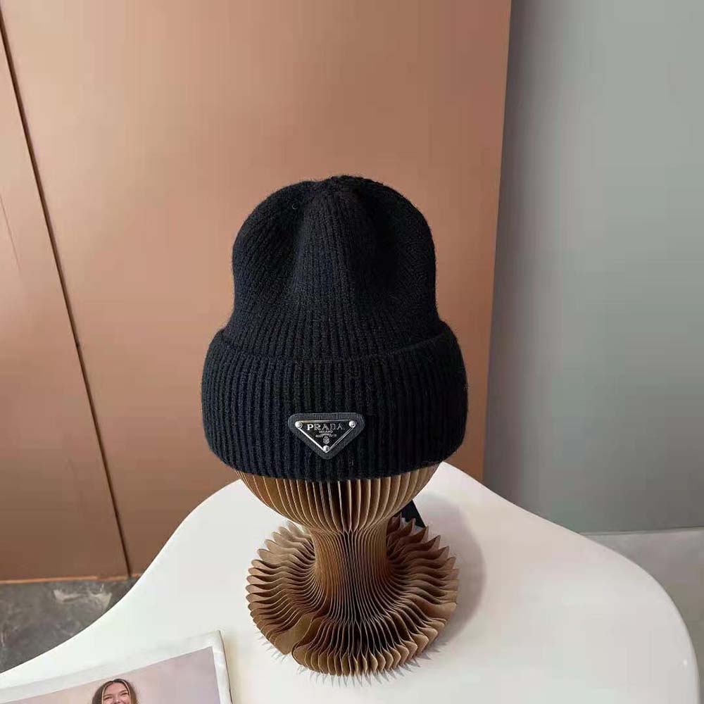 Close-up on woven Prada logo detail on black wool and cashmere beanie