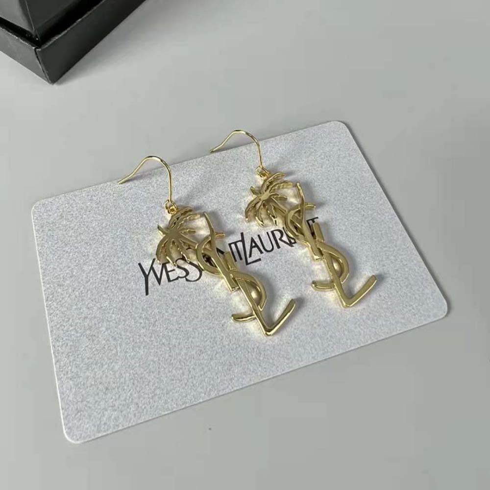 Close-up of gold YSL monogram detail on Saint Laurent Palm Earrings