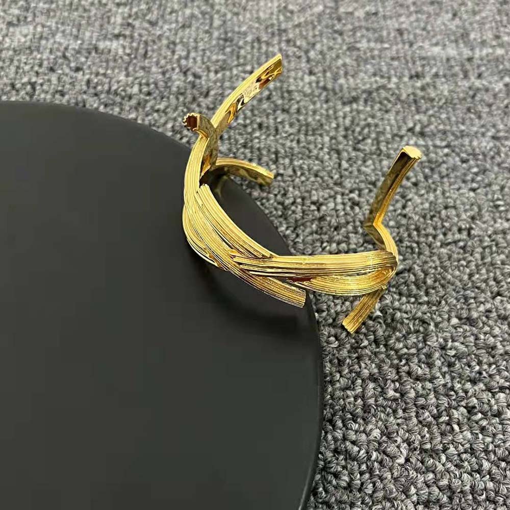 Saint Laurent YSL Women Opyum Twist Cuff Bracelet worn on wrist with light reflection