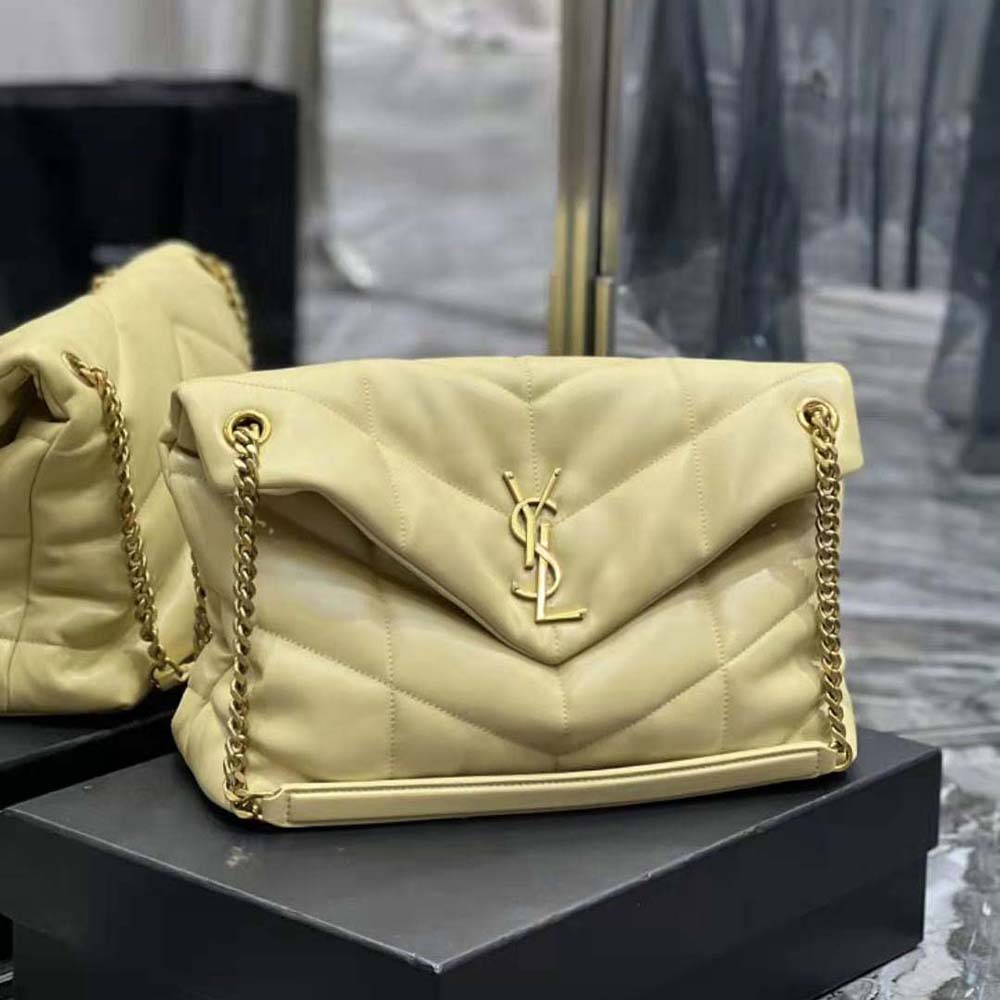 Side profile showing the gold chain strap and puffer silhouette bag