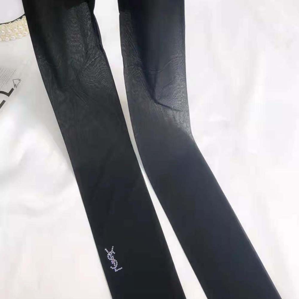 Side angle showing sheer fabric texture of Saint Laurent YSL black tights