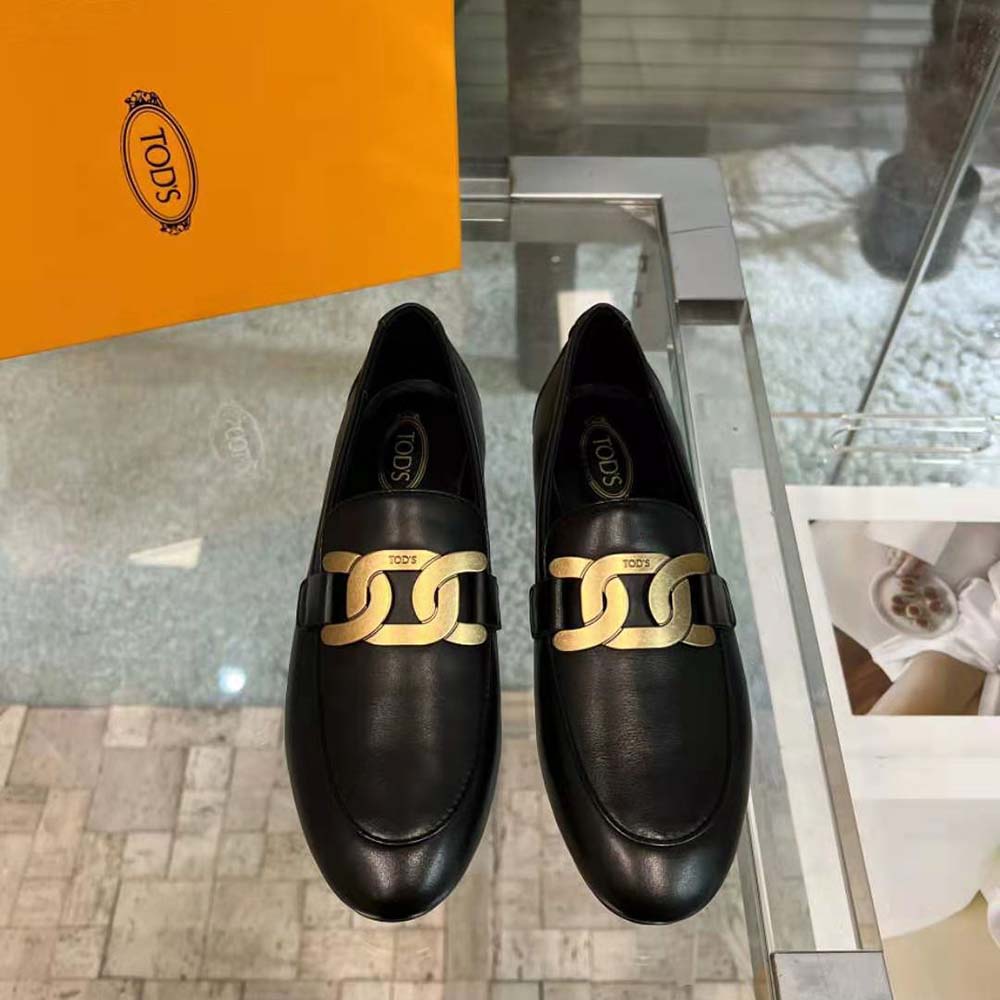 Close-up of metal branded detail on TODS Women Kate Loafers black leather