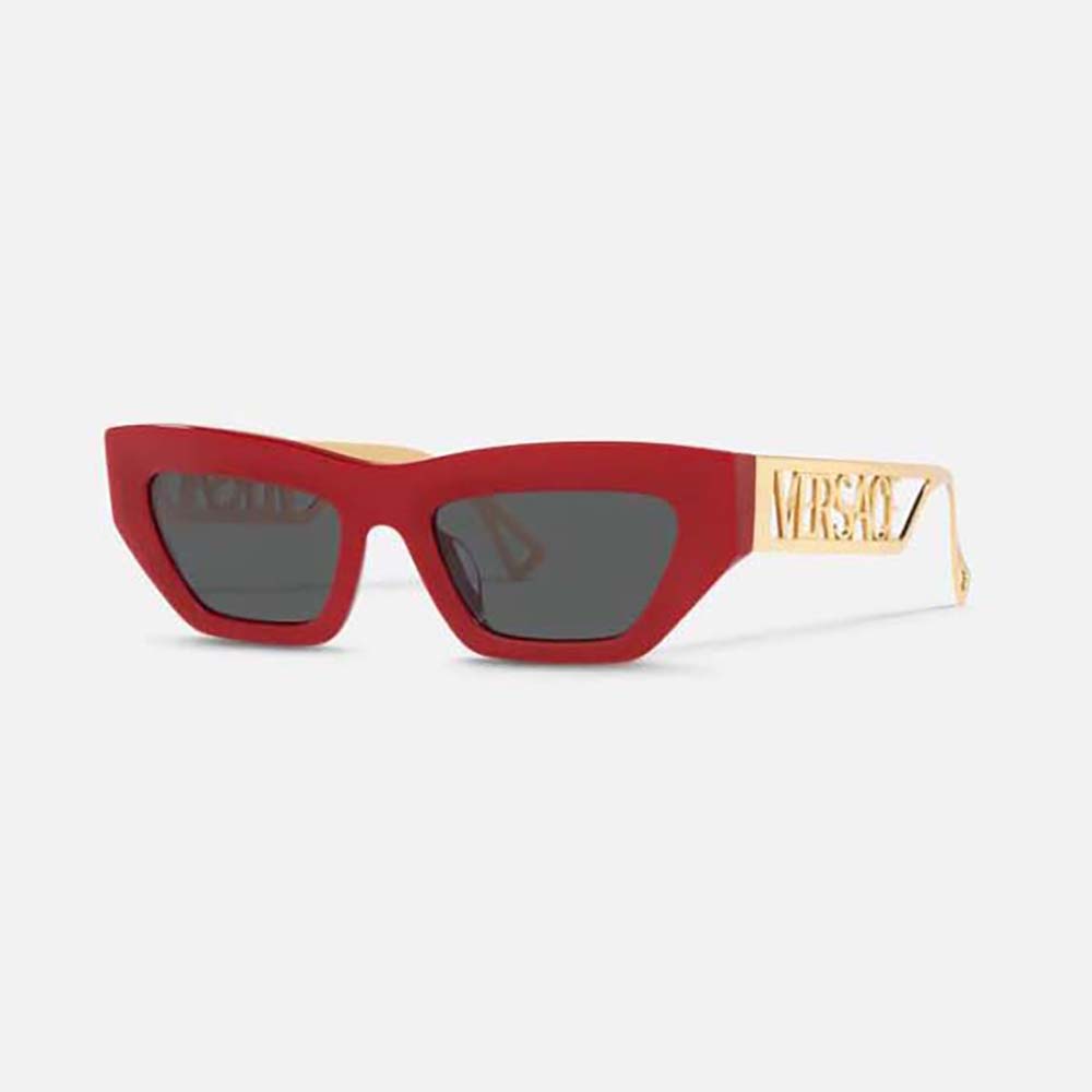 Close-up of gold Medusa logo on red cat-eye sunglasses by Versace