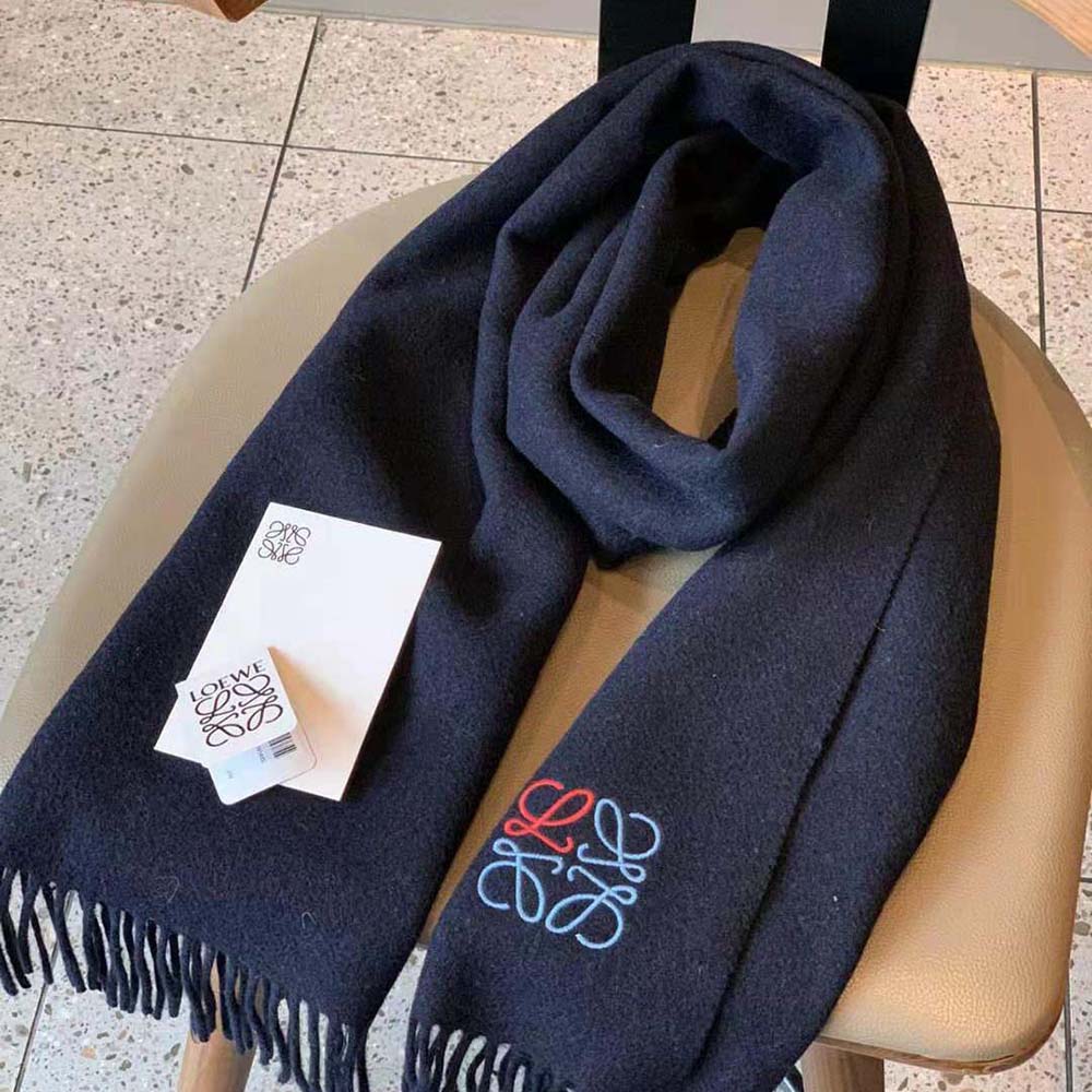 Loewe Women Anagram Scarf in Cashmere-Navy Blue draped on model’s shoulders