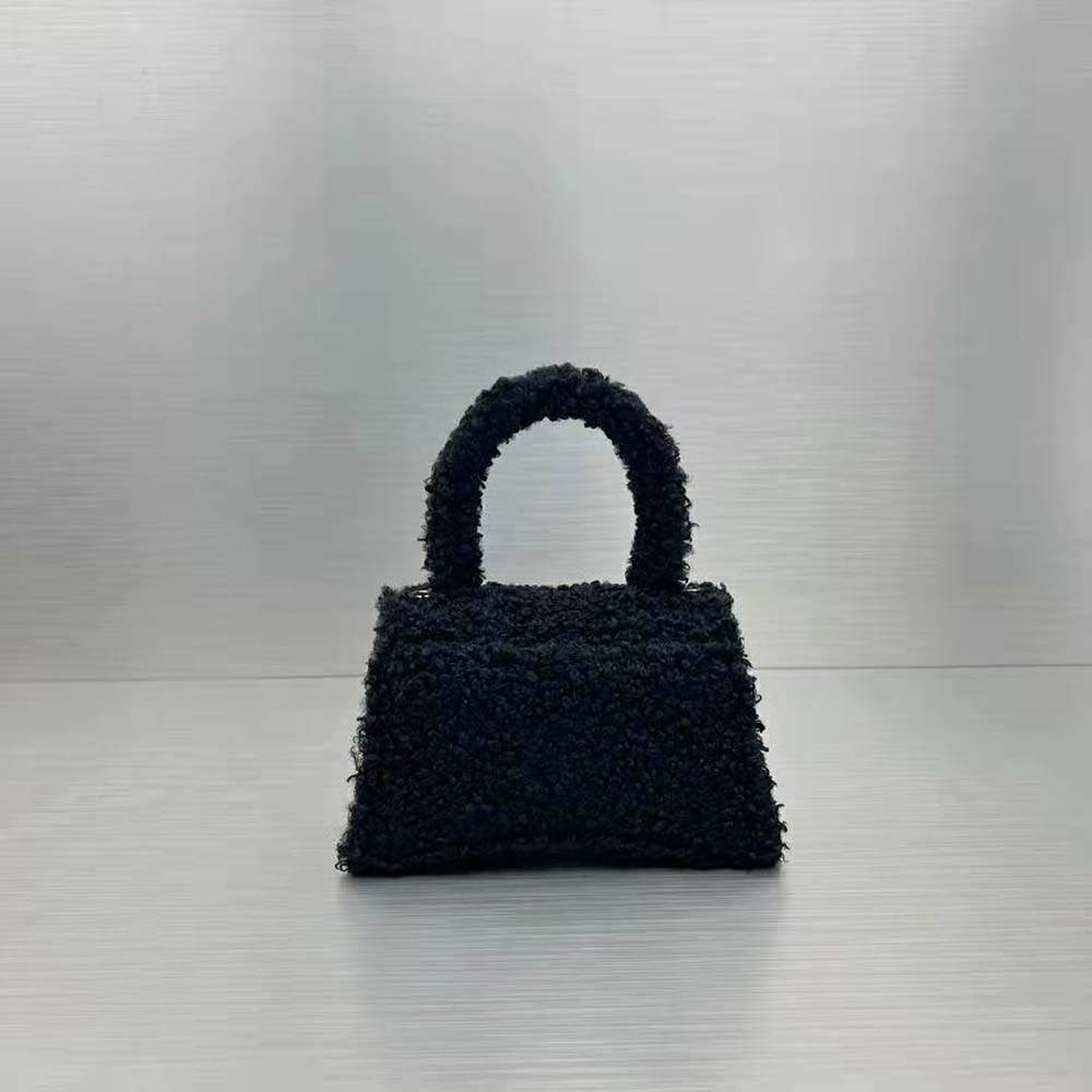 Side angle showing plush black fur texture on Balenciaga small handbag