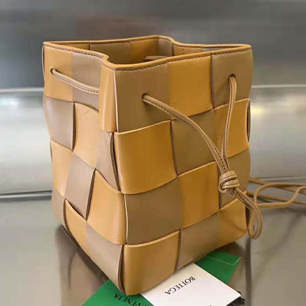 Side angle of Bottega Veneta Women Small Cassette Cross-Body Bucket-Brown showing adjustable strap