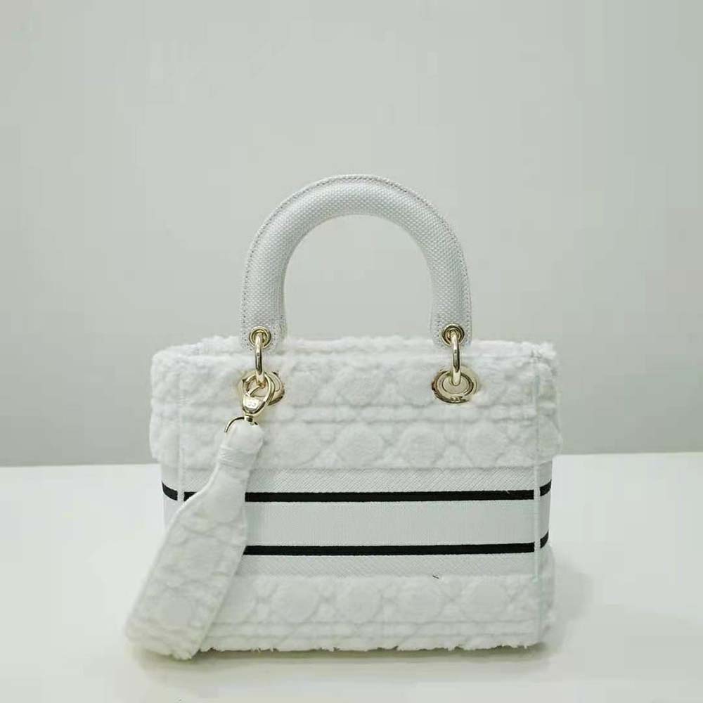 Side angle showing silver hardware and shoulder strap of Dior Lady D-lite Bag