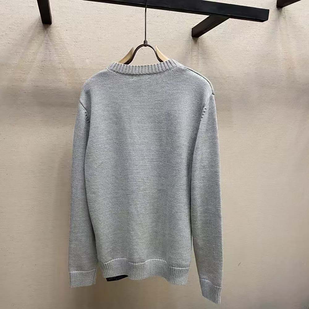 Side angle showing fit and minimalist Prada logo on sweater hem