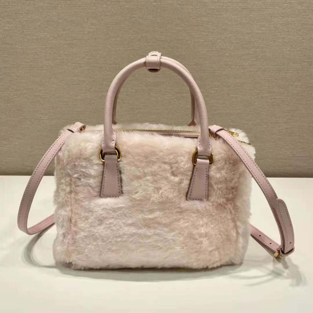 Side angle of structured silhouette and zip closure on Prada Shearling Mini-Bag