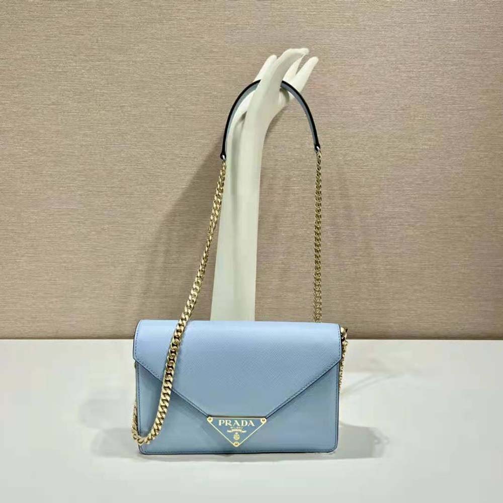 Close-up of gold-tone Prada hardware on blue saffiano leather bag