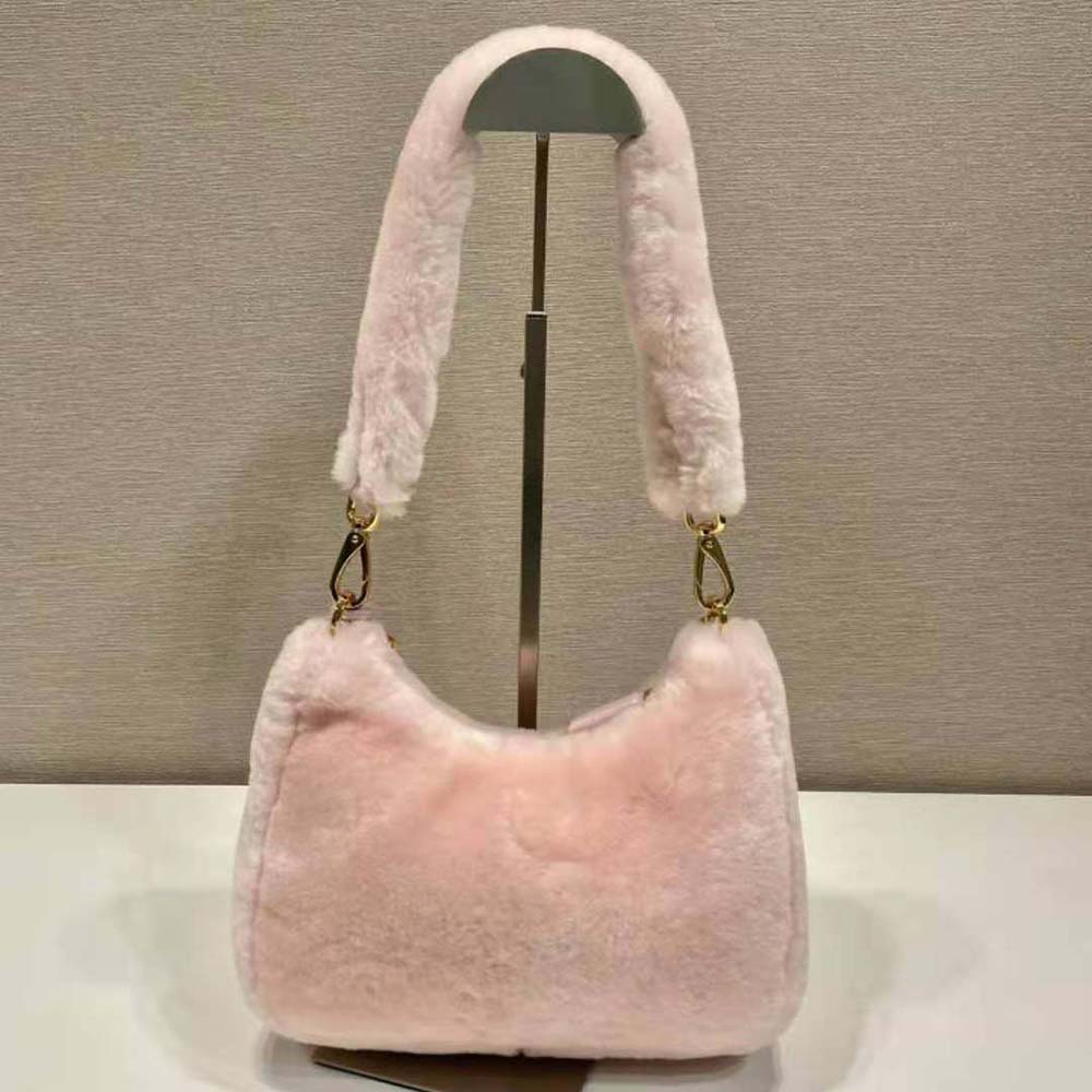 Side angle showing compact silhouette of Prada Women Shearling Mini-Bag pink