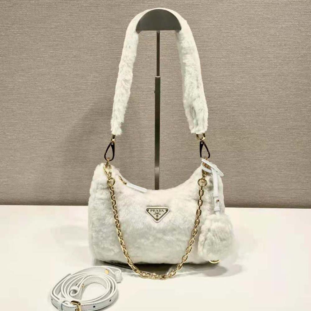 Close-up of enameled metal triangle logo on Prada mini-bag