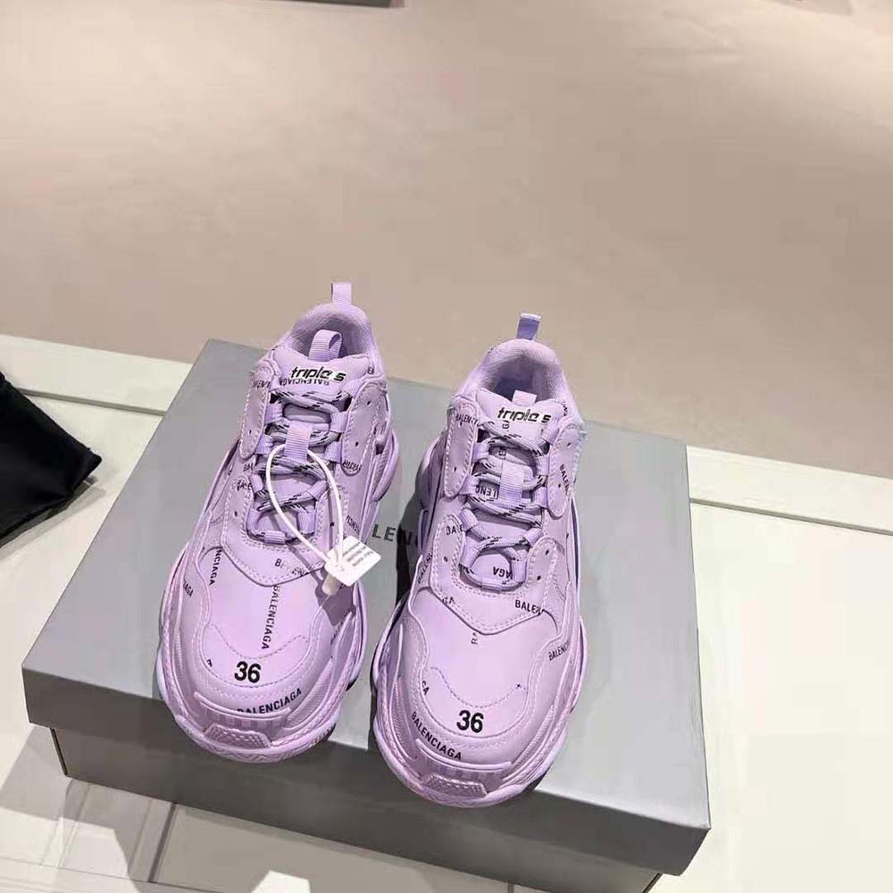 Close-up of tonal black laces and logo print on Balenciaga Triple S sneaker