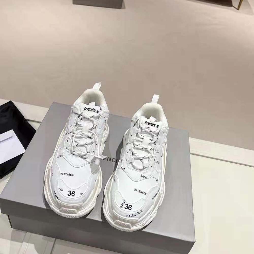 Close-up of Balenciaga Triple S sneaker layered sole and logo print detail