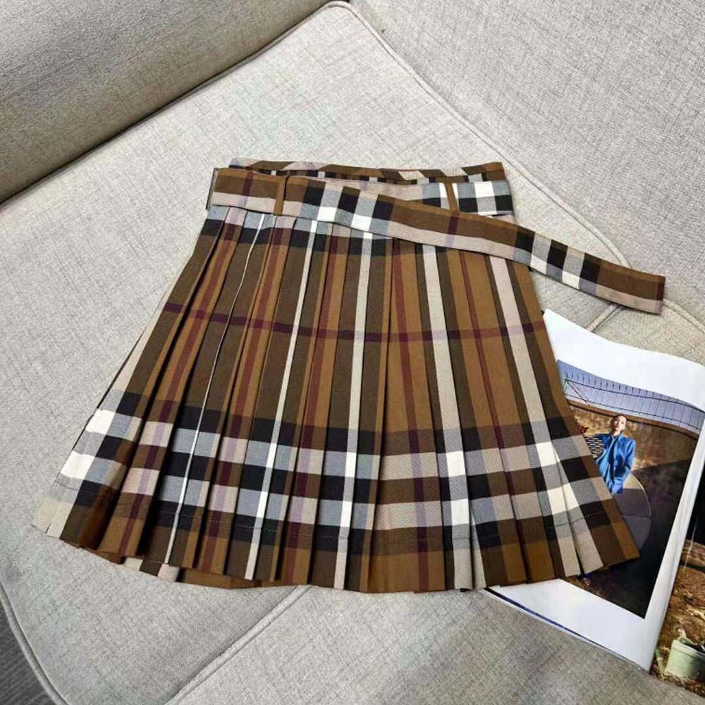 Side angle showing pleated silhouette of Burberry Women Check Wool Pleated Skirt