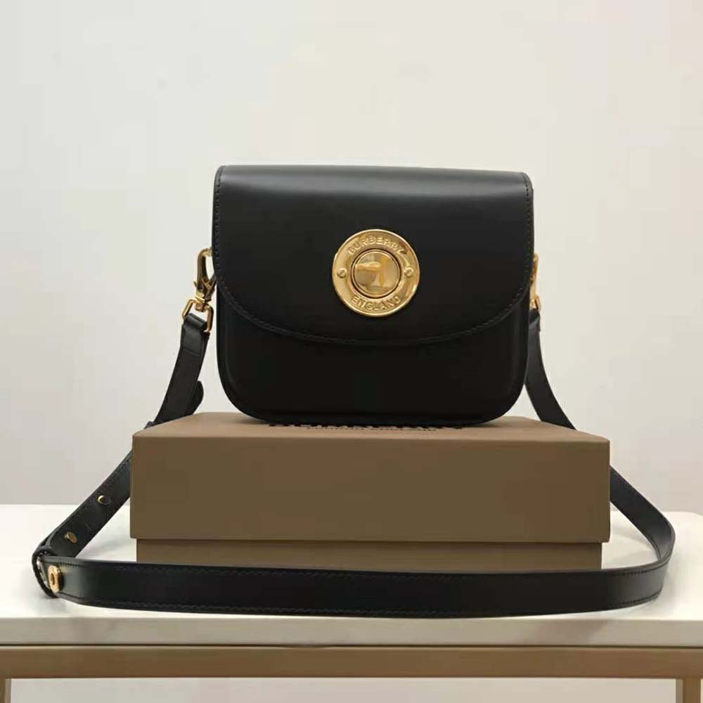 Close-up on smooth black leather and gold-tone hardware detail