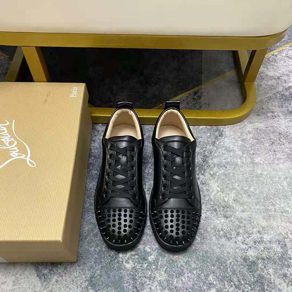 Close-up of signature spikes and black leather on Christian Louboutin Men Louis Junior Spikes-Black