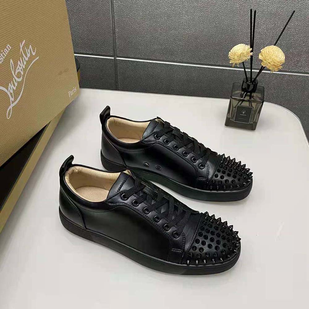 Side profile showcasing red sole on Christian Louboutin Men Louis Junior Spikes-Black