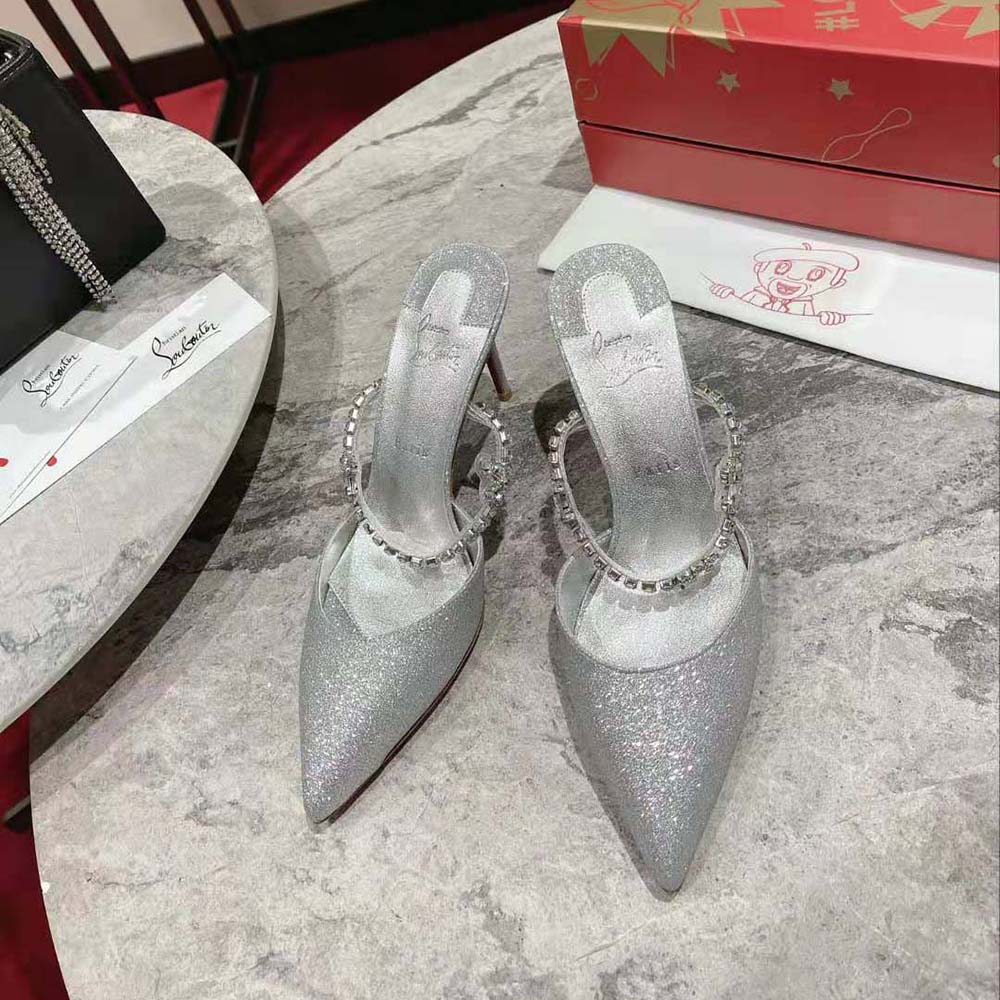 Close-up on metallic silver ankle buckle and leather of Planet Queen heels