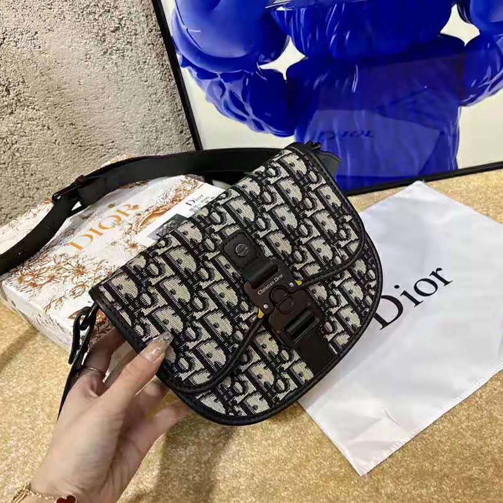 Side angle showing compact silhouette and zip closure of Dior Men Mini Gallop Bag
