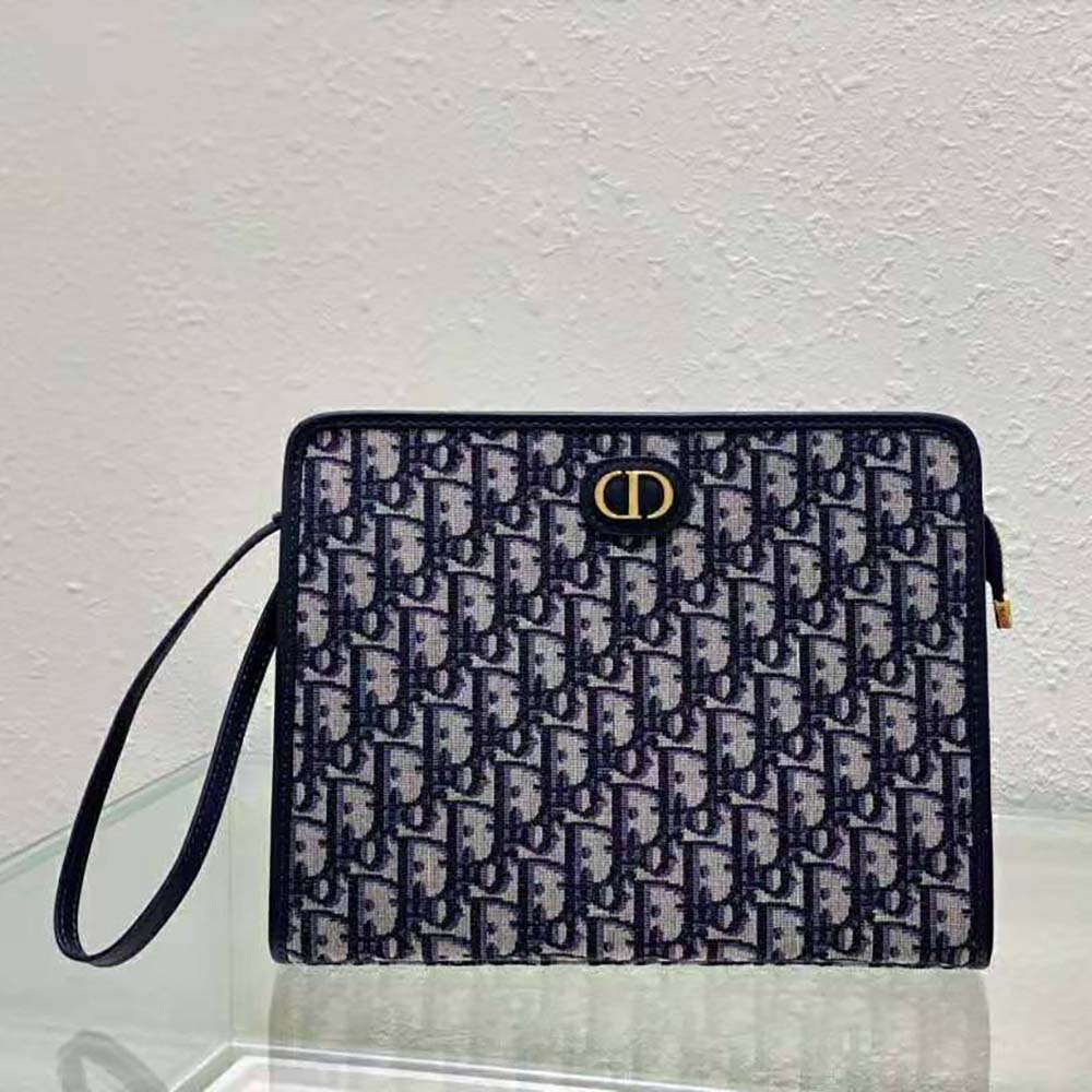 Close-up of blue jacquard fabric and silver hardware on Dior pouch