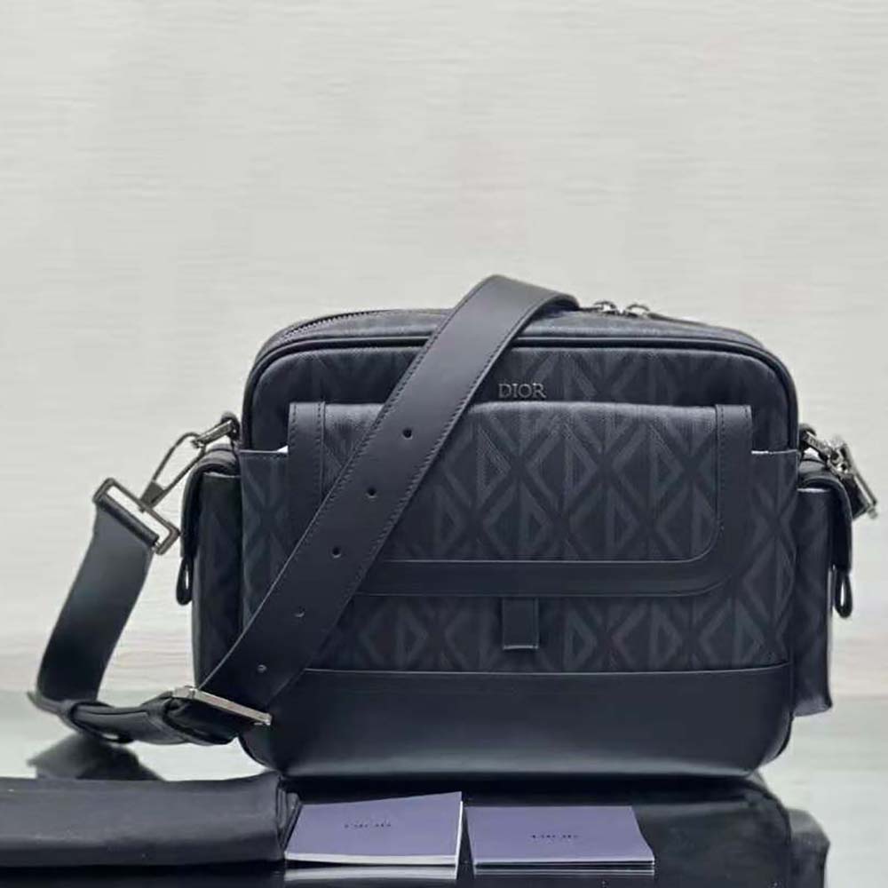 Close-up detail of silver CD hardware on Dior Men Hit the Road Messenger Pouch