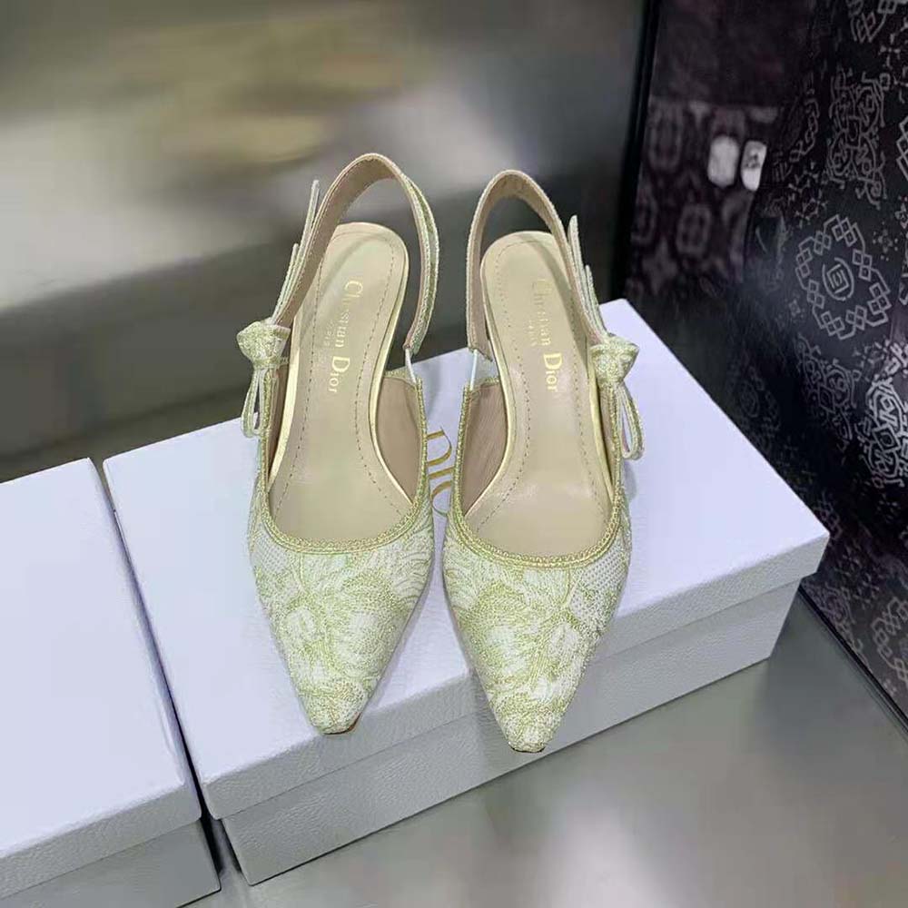 Close-up detail of gold-tone embroidery and hardware on Dior pump