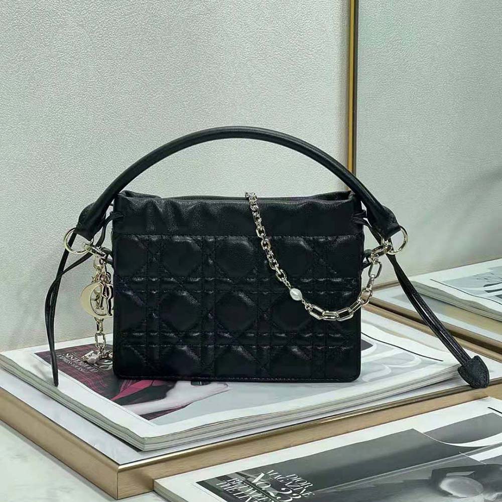 Close-up of black lambskin texture and silver hardware on Lady Dior mini bag