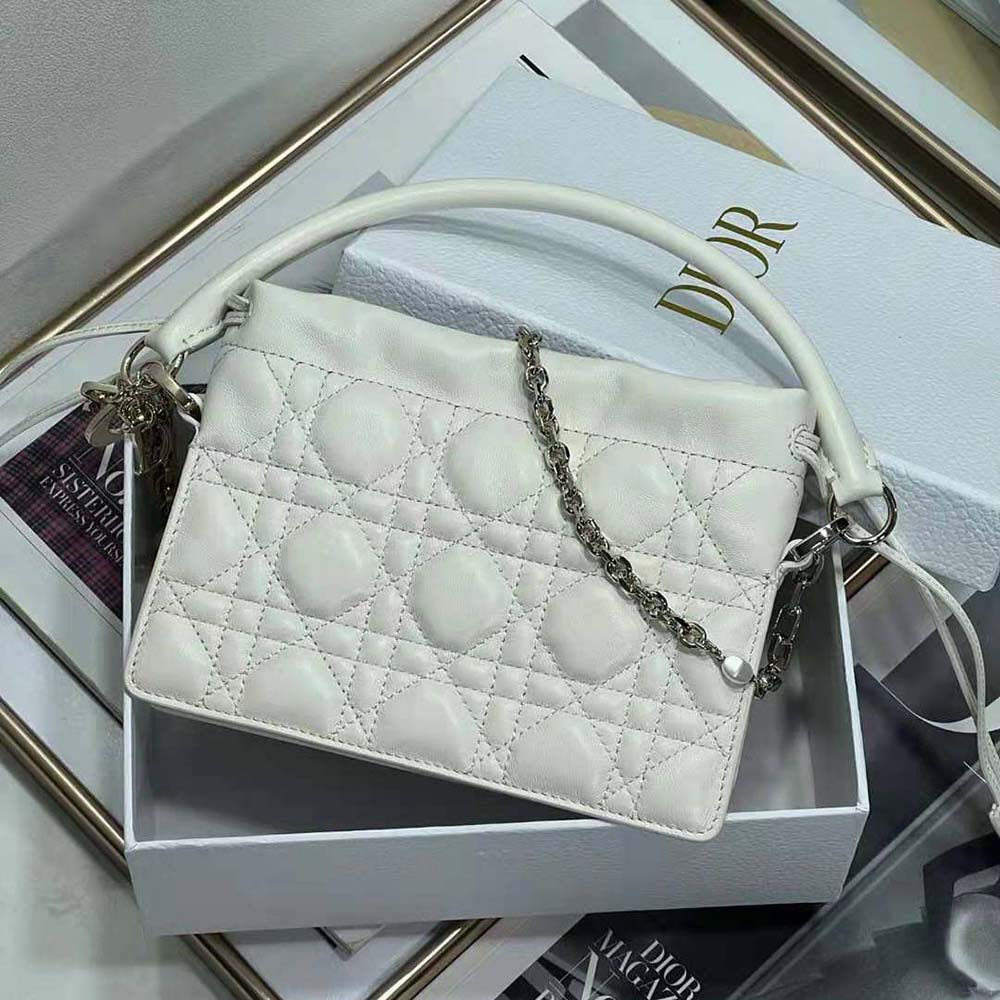 Side angle showing drawstring closure and silver hardware on Dior Lady Dior bag