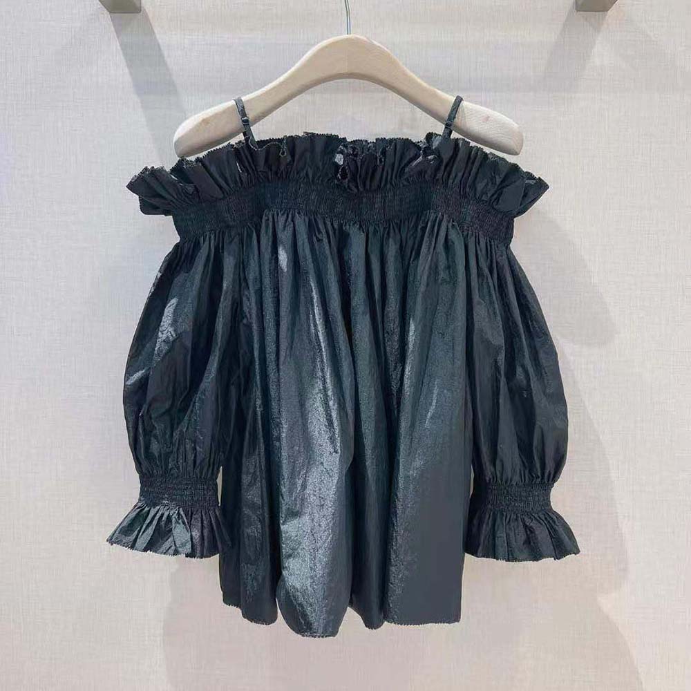 Side angle showing silhouette and hidden zip of Dior black silk top