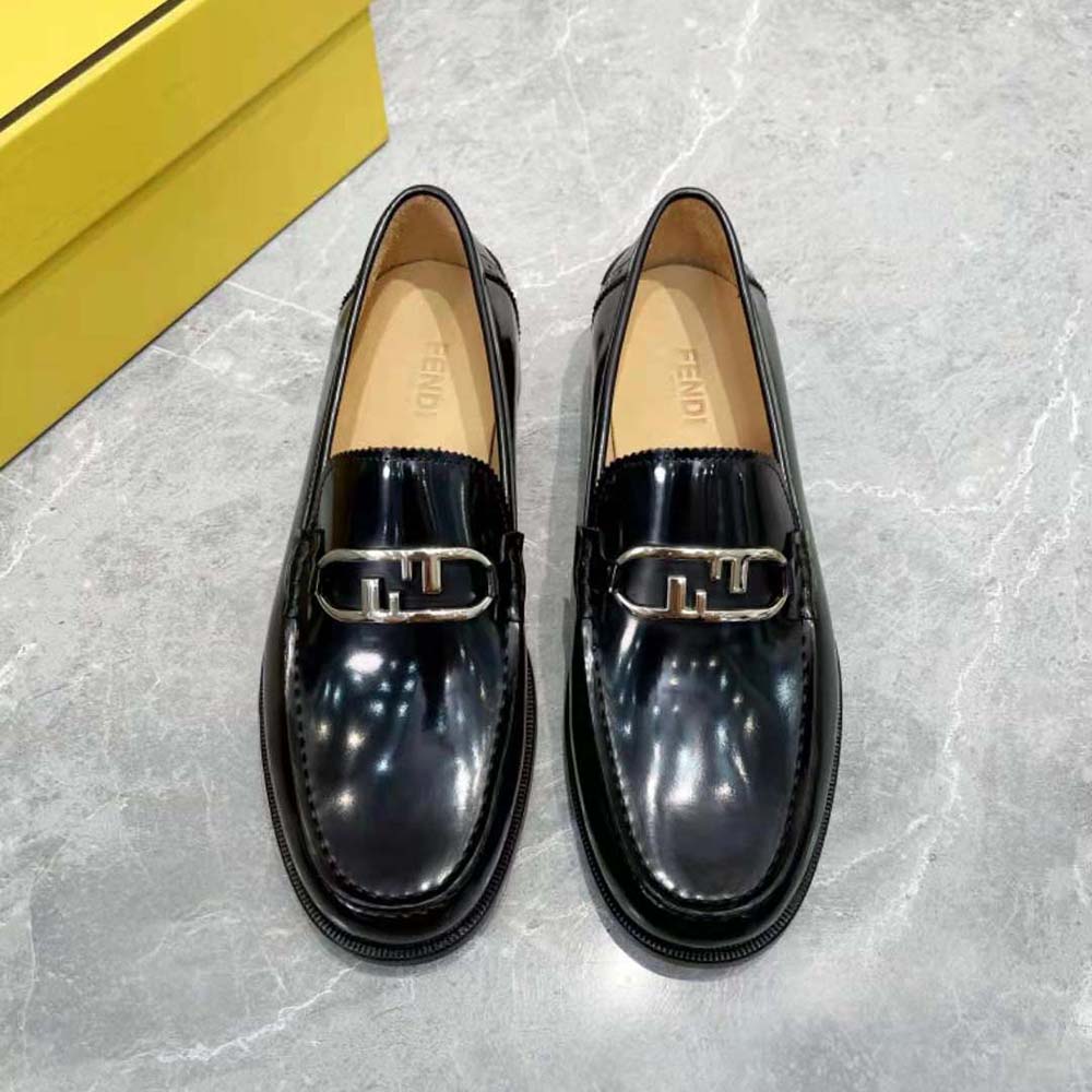 Close-up detail of O’Lock metal hardware on Fendi loafers