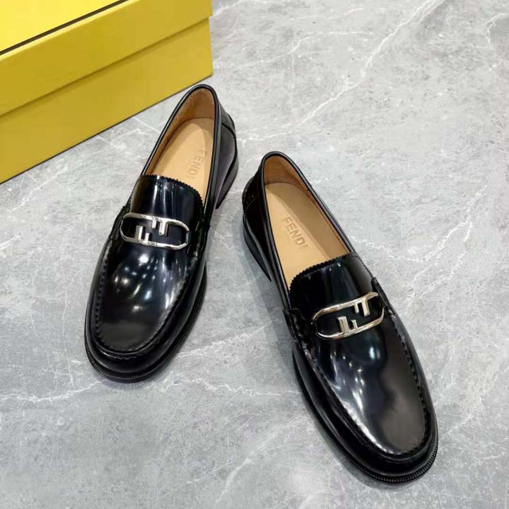 Overhead shot highlighting black leather texture of Fendi loafers